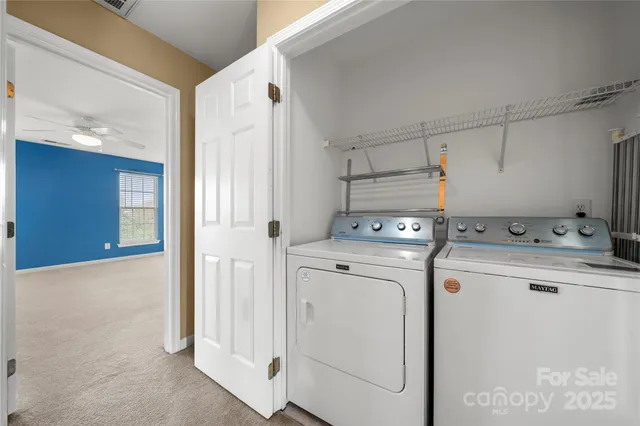 a view of a storage & utility room with dryer and washer