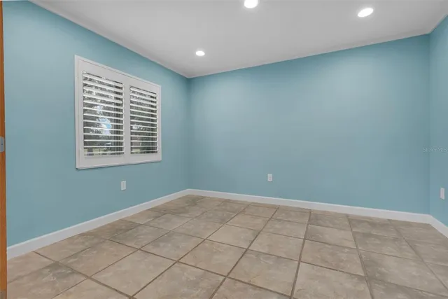 a view of empty room with a fireplace