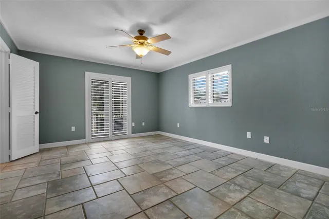 a view of a livingroom with an empty space and a window