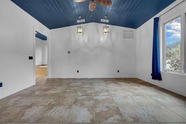 a view of a livingroom with a ceiling fan and window