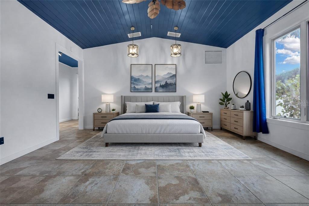 307 West 4th Avenue Windermere, FL 34786 - Photo 37 of 56 a spacious bedroom with a bed a table and a large window