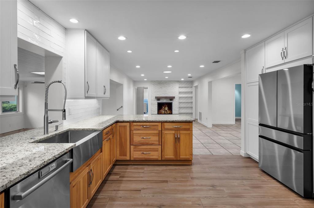 307 West 4th Avenue Windermere, FL 34786 - Photo 5 of 56 a large kitchen with stainless steel appliances granite countertop a large counter top a sink and a refrigerator