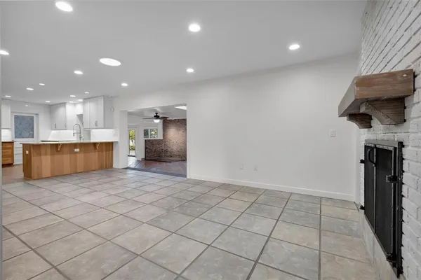 a view of a kitchen with a sink and a refrigerator