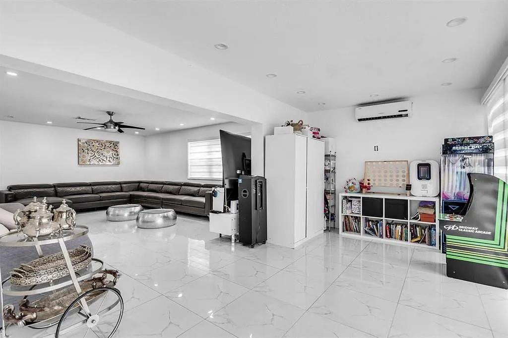 4100 North 36th Avenue Hollywood, FL 33021 - Photo 4 of 12 a living room with furniture a flat screen tv and a table