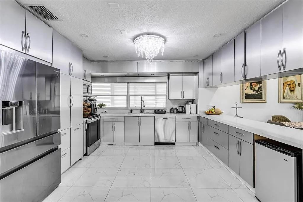 4100 North 36th Avenue Hollywood, FL 33021 - Photo 7 of 12 a large kitchen with cabinets and stainless steel appliances