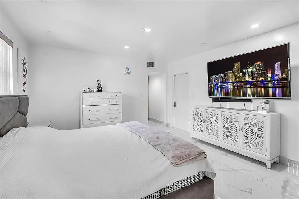 4100 North 36th Avenue Hollywood, FL 33021 - Photo 10 of 12 a bedroom with a bed and a flat screen tv