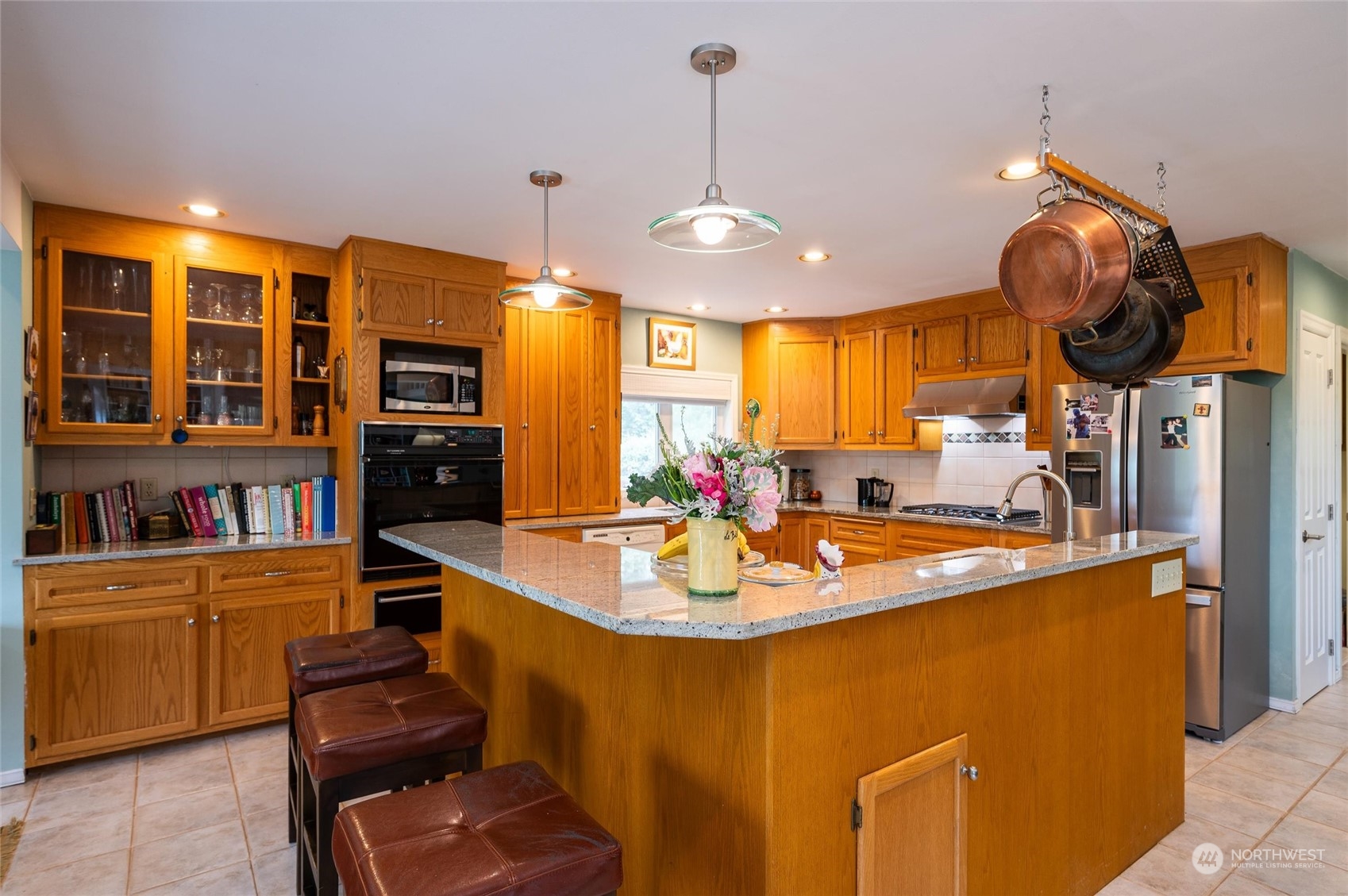 1835 High Noon Road Bellingham, WA 98226 - Photo 12 of 40 a kitchen with stainless steel appliances granite countertop a sink a stove and a wooden floors