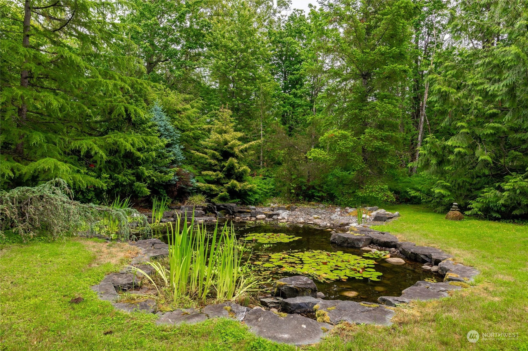 1835 High Noon Road Bellingham, WA 98226 - Photo 32 of 40 a view of a garden with a bench