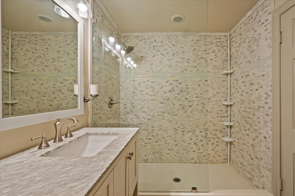 601 North Main Street Leonard, TX 75452 - Photo 19 of 34 a bathroom with a granite countertop sink a toilet and shower