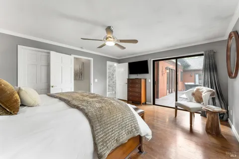 a bedroom with a bed and glass door