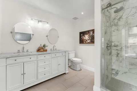 a bathroom with a toilet a sink and mirror