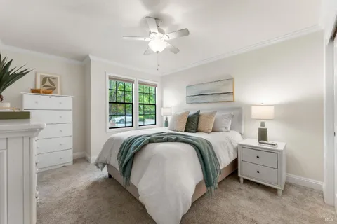 a spacious bedroom with a bed and a chandelier