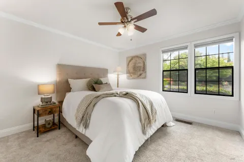 a bedroom with a bed and a large window