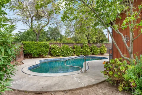 a view of a swimming pool in a back yard