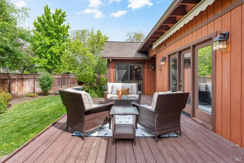 a view of a house with backyard porch and sitting area