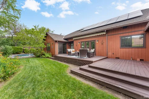 a view of a backyard with sitting area