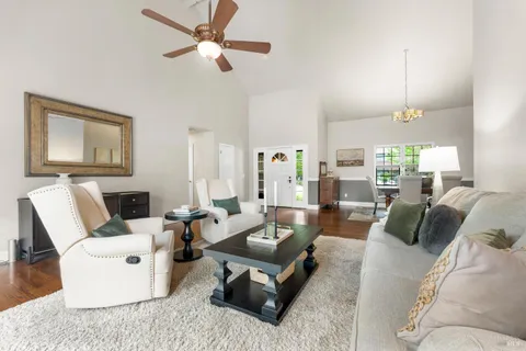 a living room with furniture a rug and white walls