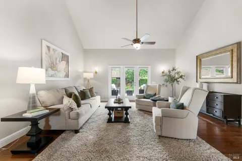 a living room with furniture or couch and a chandelier