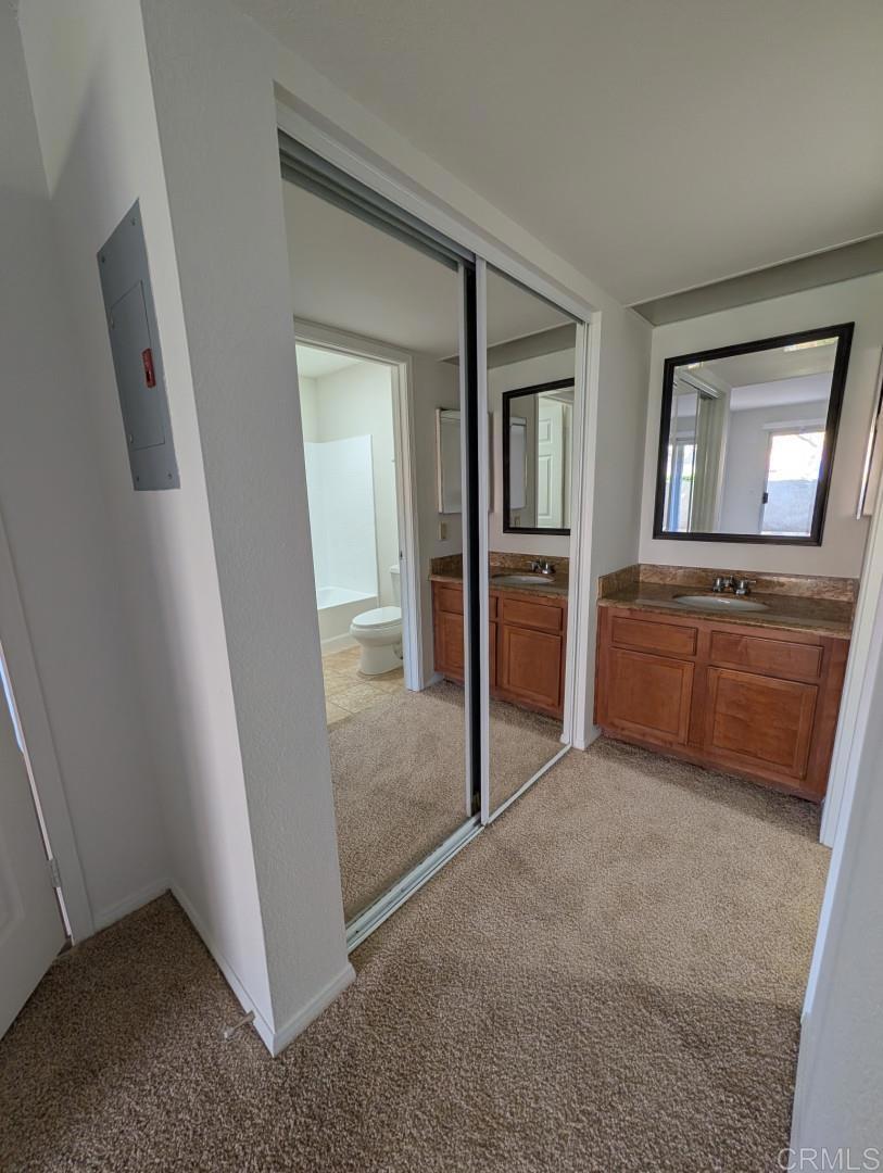 200 East Alessandro Boulevard, Unit 34 Riverside, CA 92508 - Photo 13 of 22 an empty room with mirror and a sink