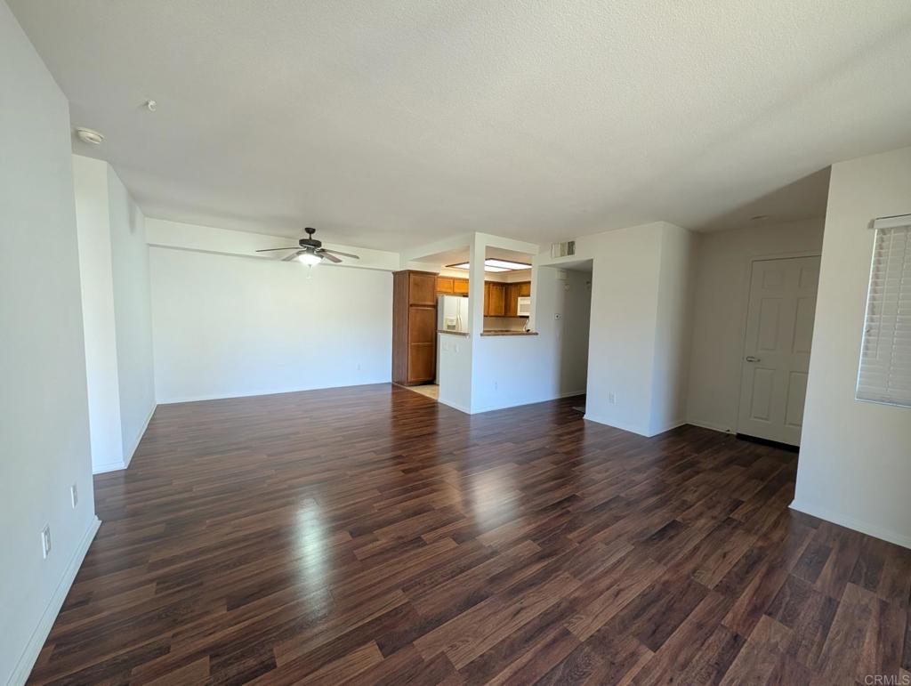 200 East Alessandro Boulevard, Unit 34 Riverside, CA 92508 - Photo 4 of 22 an empty room with wooden floor and windows