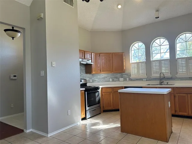 a large bathroom with a granite countertop sink a large mirror and a bathtub