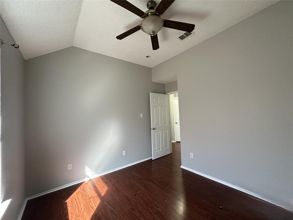 2017 Birch Bend Mesquite, TX 75181 - Photo 14 of 30 an empty room with wooden floor and ceiling fan