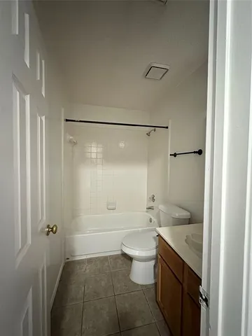 a bathroom with a granite countertop sink a toilet and shower