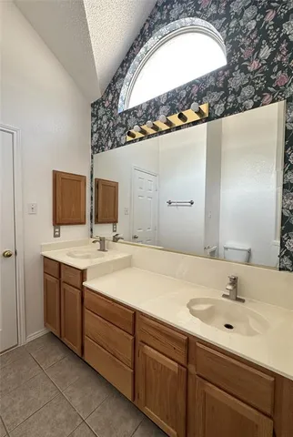 a bathroom with a double vanity sink and mirror