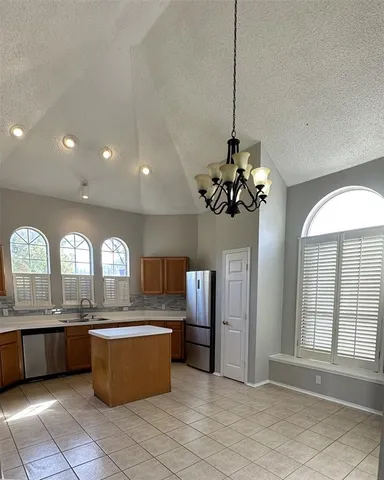 a view of a kitchen with a sink and cabinets