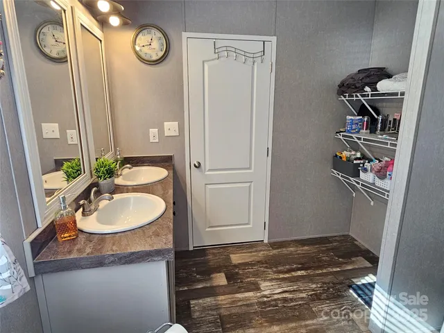 a bathroom with a sink a toilet and a mirror