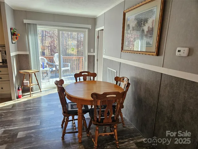 a view of a dining room with furniture large window and wooden floor