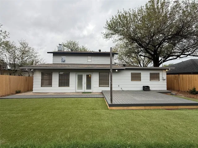 a house that has a tree in front of it