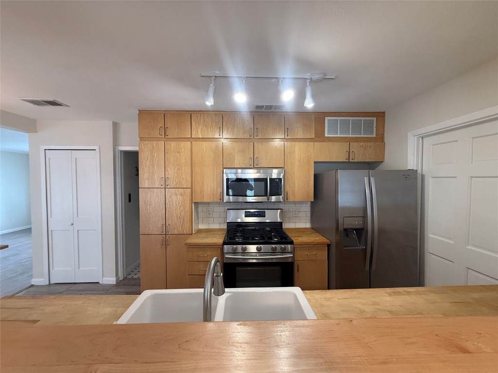 5413 Coventry Lane Austin, TX 78723 - Photo 8 of 25 a kitchen with a refrigerator and a sink