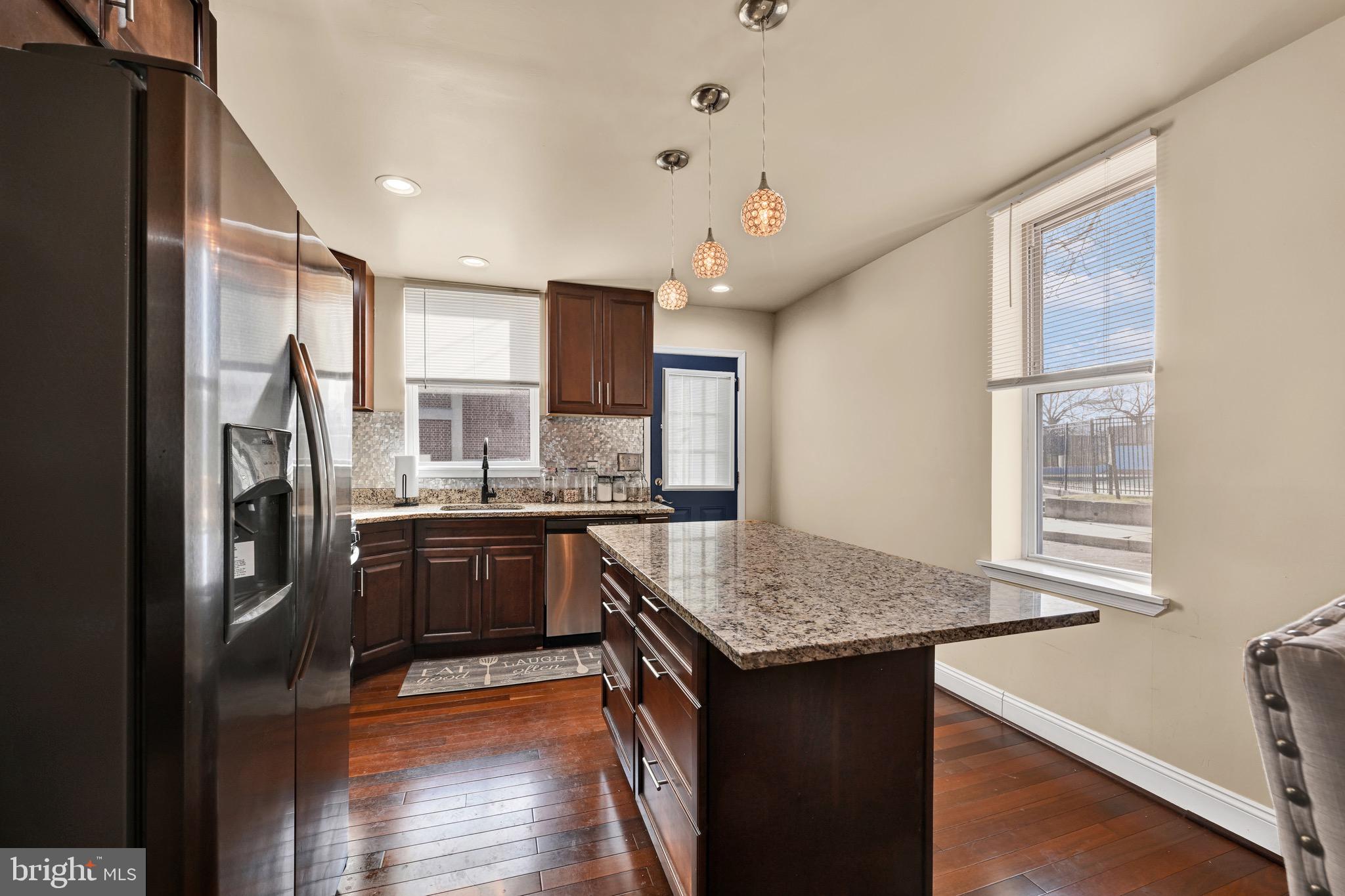 1401 East Lanvale Street Baltimore, MD 21213 - Photo 2 of 17 a kitchen with stainless steel appliances granite countertop a sink stove and refrigerator