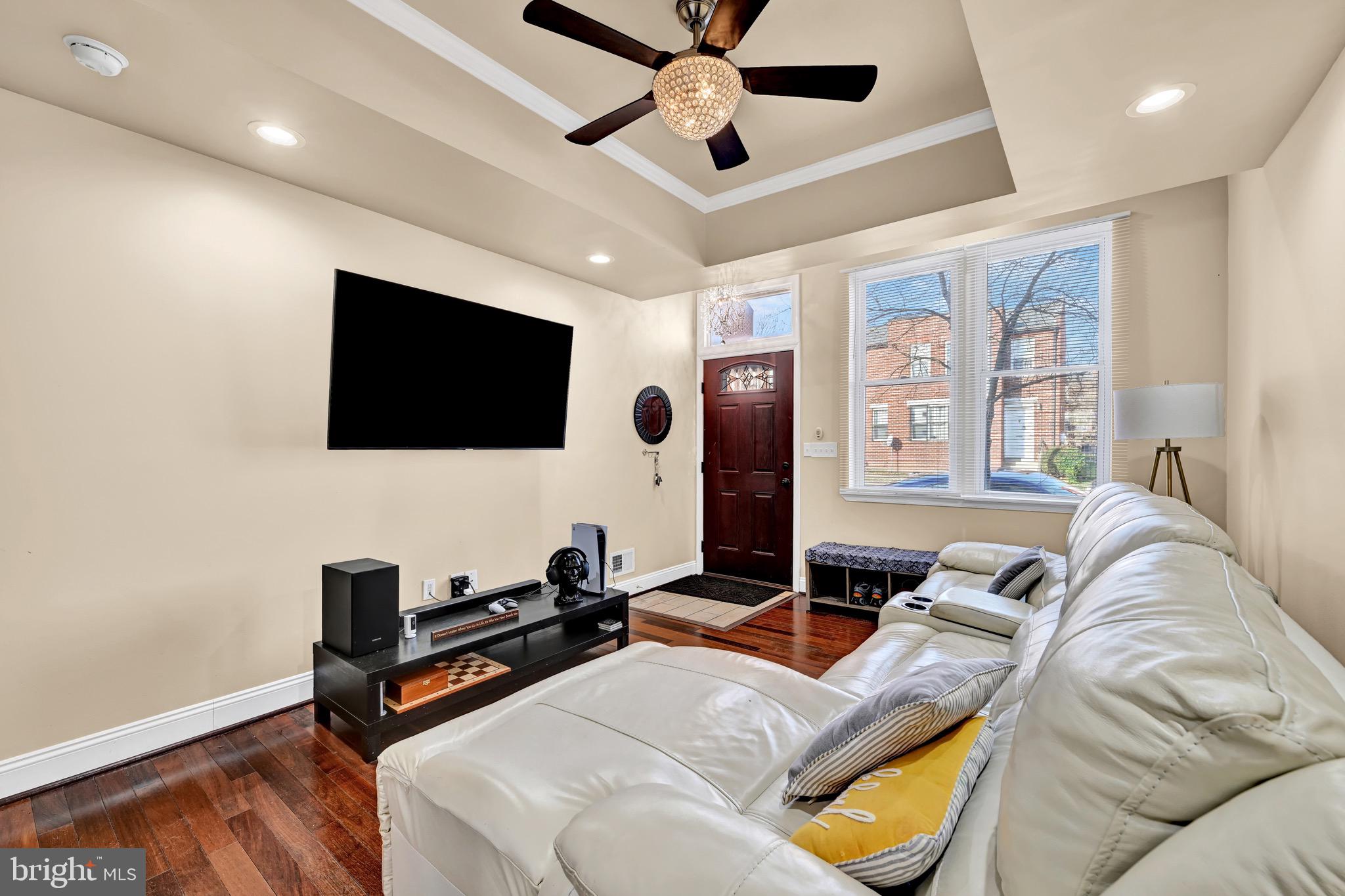 1401 East Lanvale Street Baltimore, MD 21213 - Photo 4 of 17 a living room with furniture and a flat screen tv