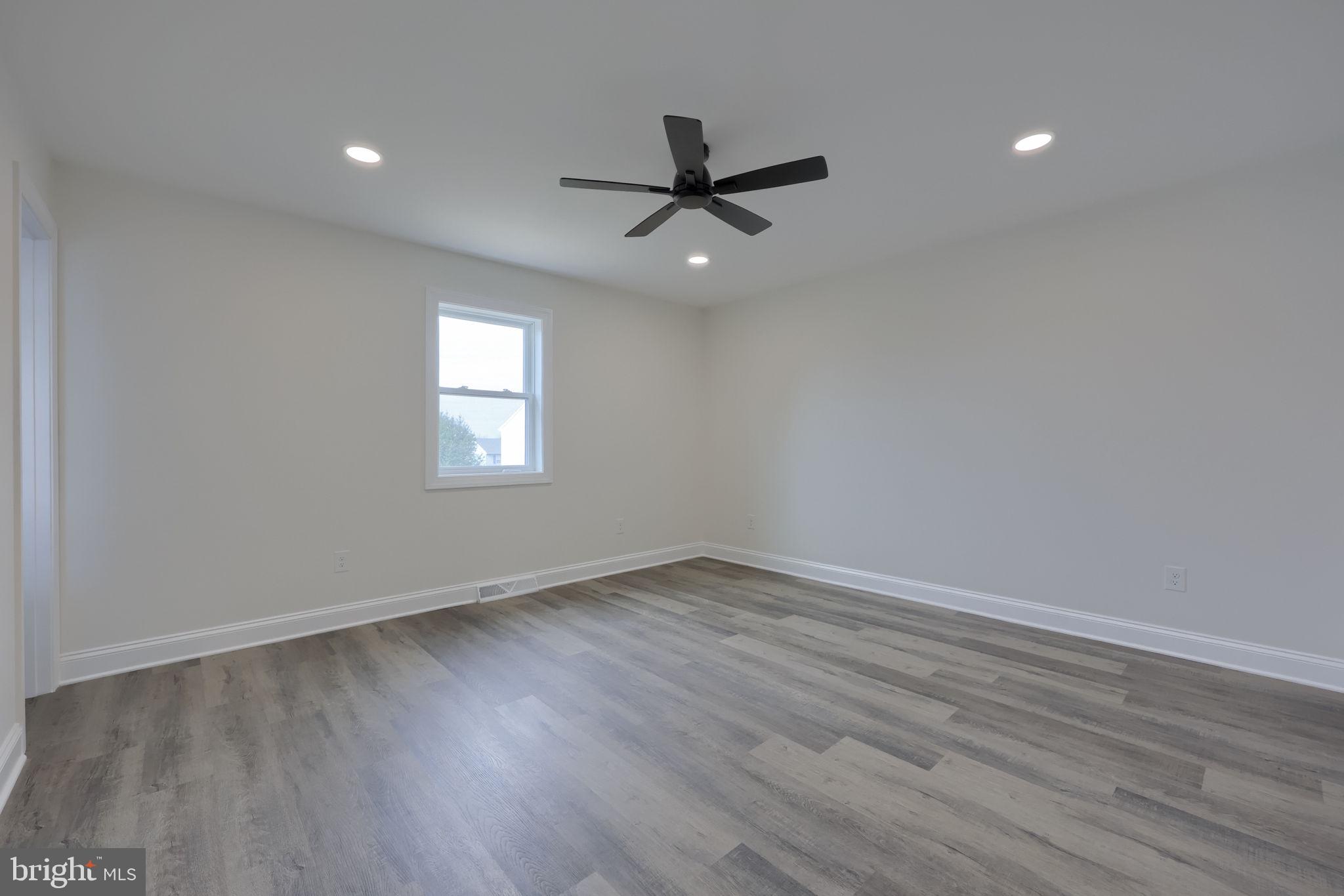 310 Kendale Road Red Lion, PA 17356 - Photo 24 of 42 an empty room with wooden floor and windows