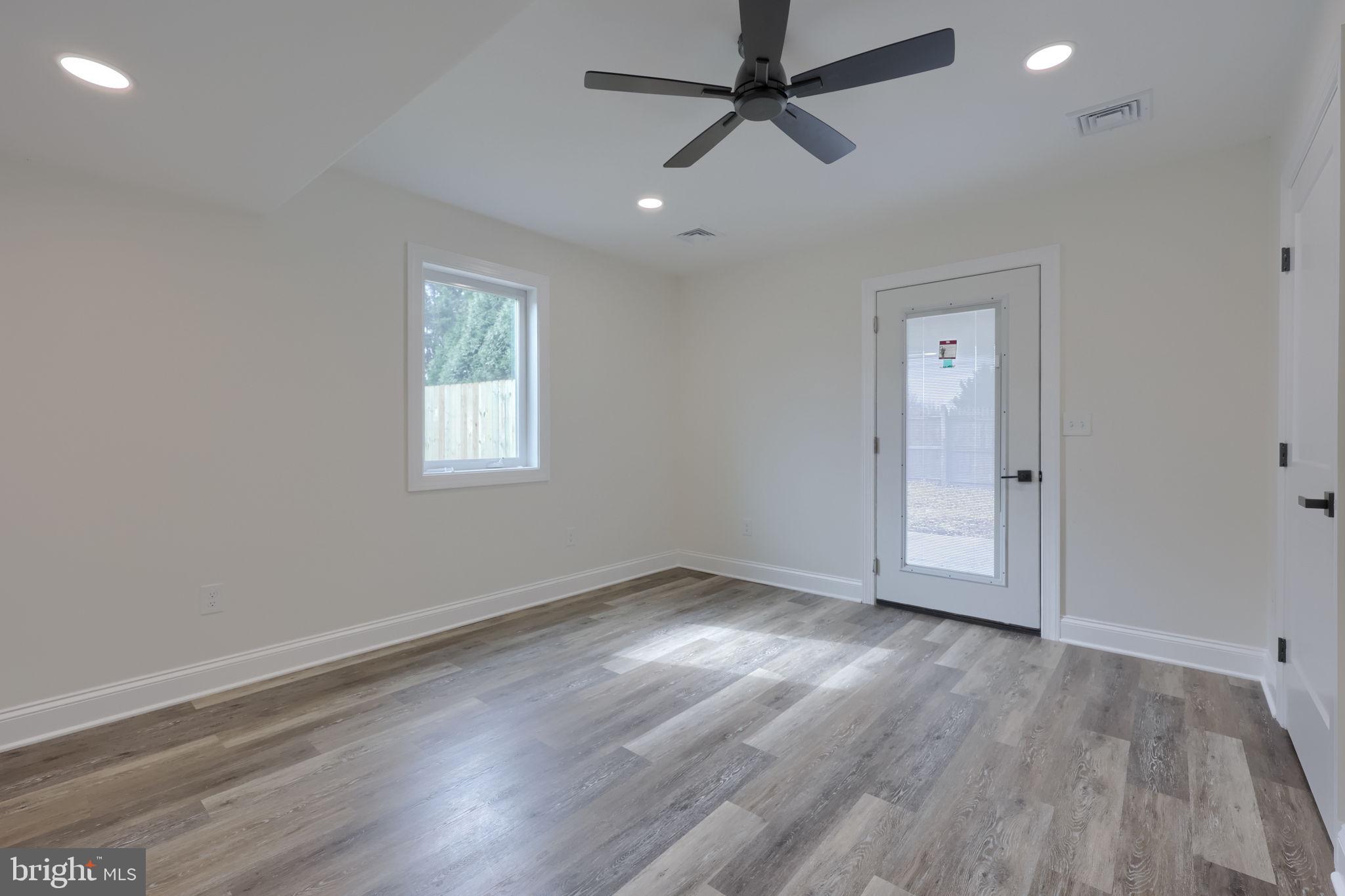 310 Kendale Road Red Lion, PA 17356 - Photo 32 of 42 an empty room with wooden floor ceiling fan and windows