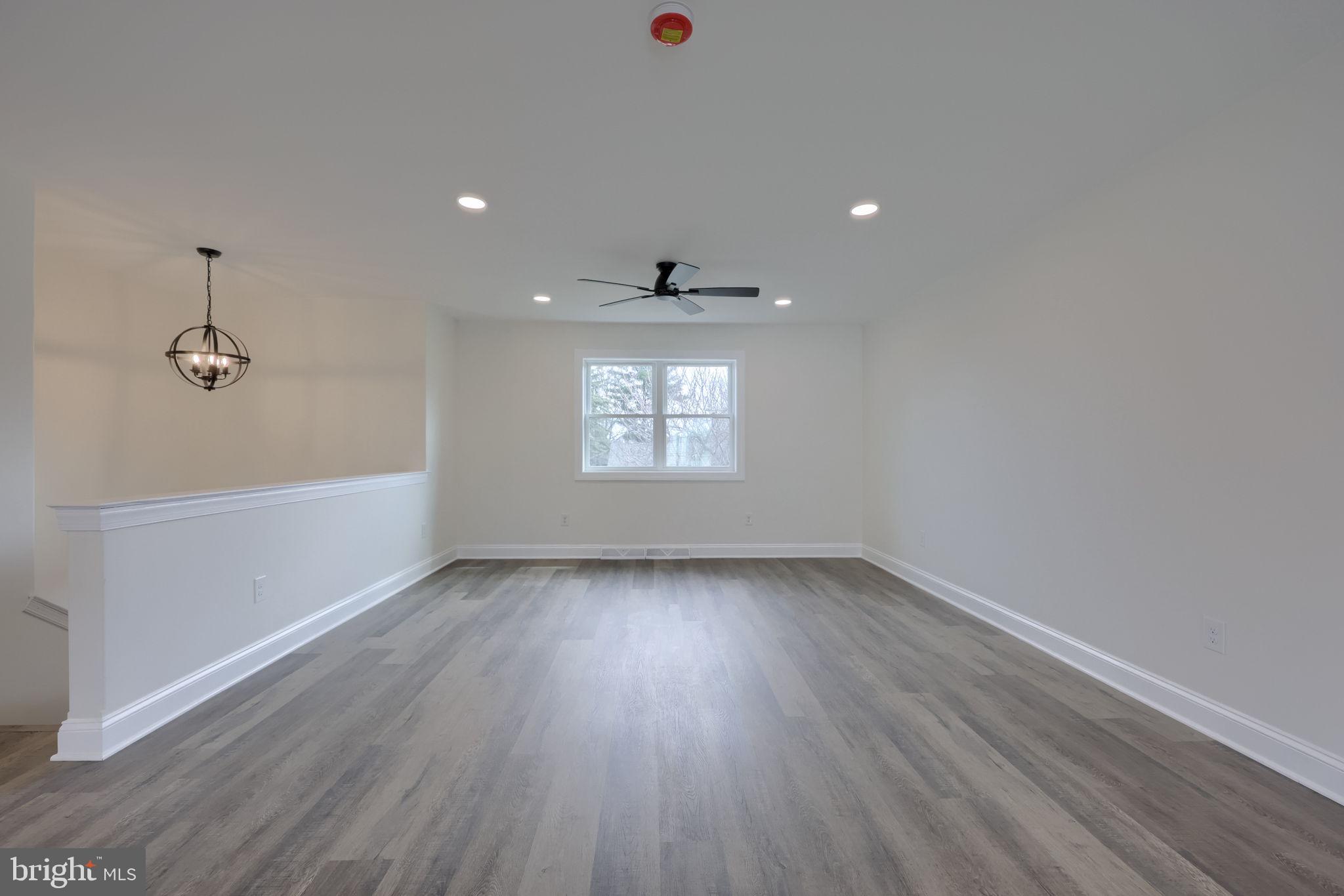 310 Kendale Road Red Lion, PA 17356 - Photo 5 of 42 an empty room with wooden floor and windows