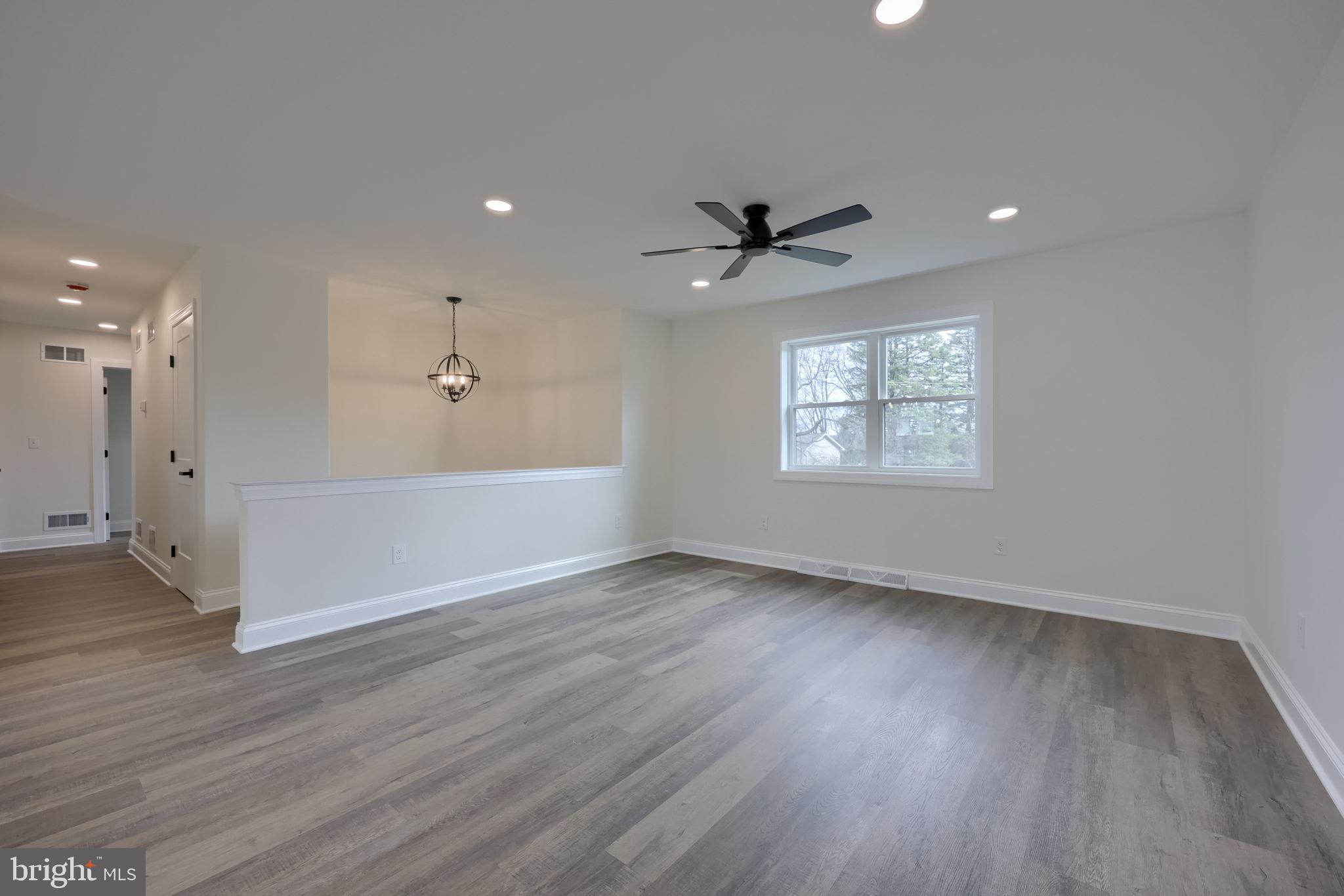 310 Kendale Road Red Lion, PA 17356 - Photo 6 of 42 a view of an empty room with a window and wooden floor