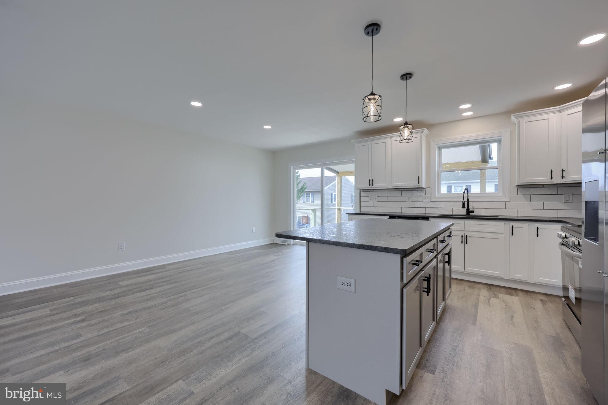 310 Kendale Road Red Lion, PA 17356 - Photo 9 of 42 a kitchen with granite countertop a sink cabinets and wooden floor