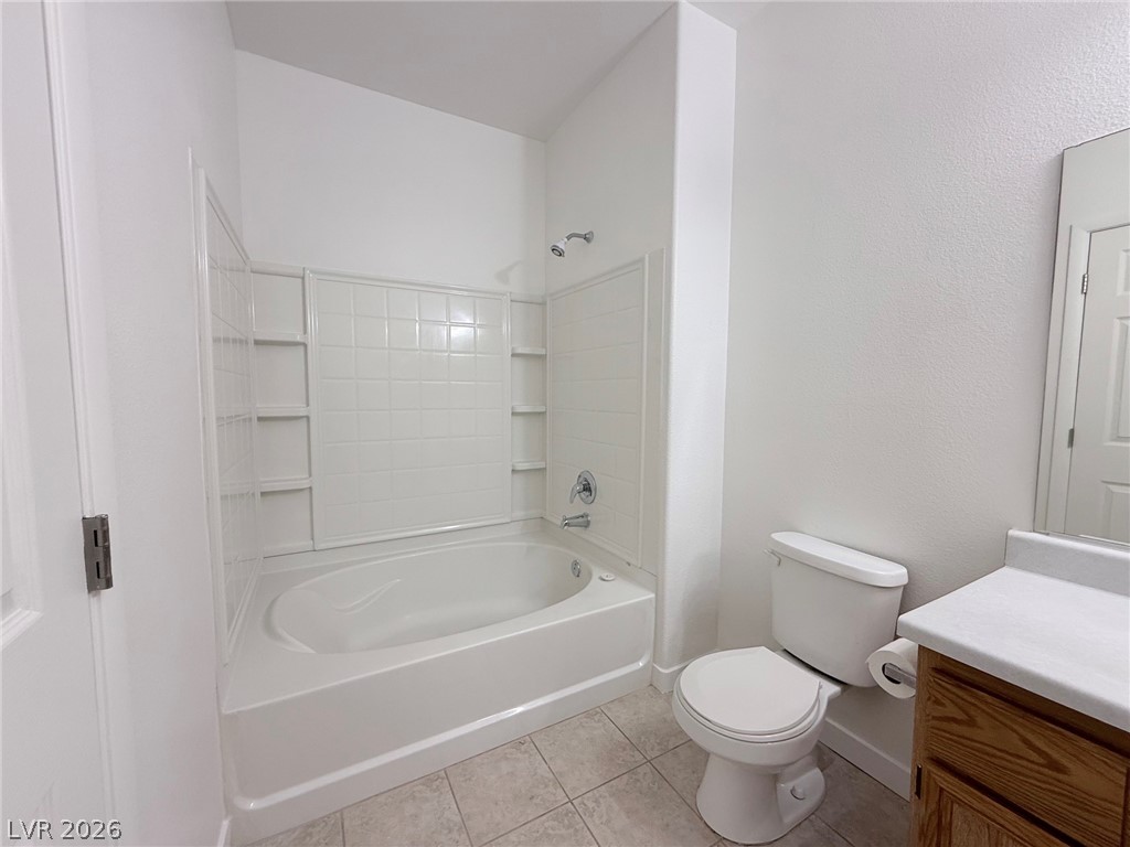 9050 West Warm Springs Road, Unit 2002 Las Vegas, NV 89148 - Photo 26 of 46 This bright bathroom features a spacious tub and tiled flooring, offering a clean and functional design.