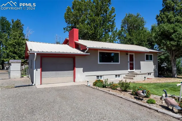 a front view of a house with a yard outdoor seating and garage