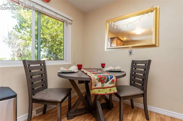a view of a dining room with furniture and a window