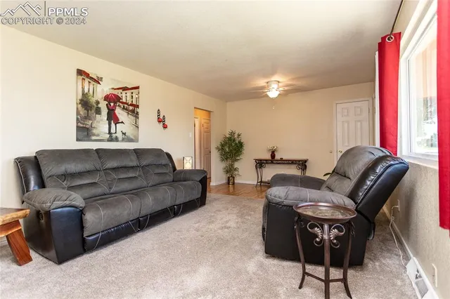 a living room with furniture and a chandelier