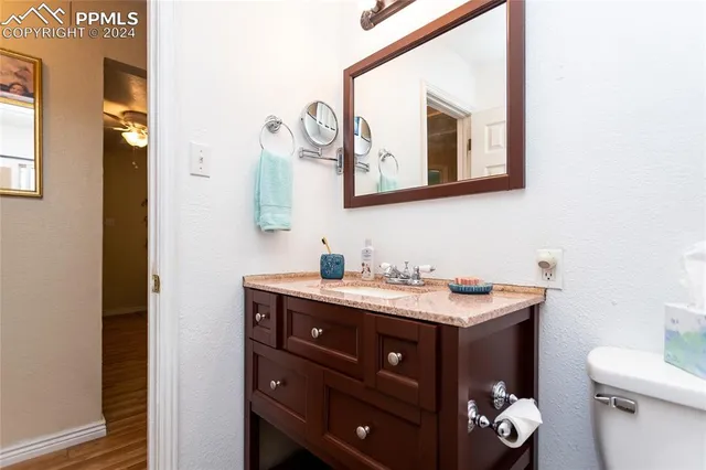 a bathroom with a toilet sink and mirror
