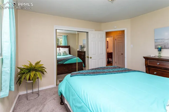 a bedroom with a bed and a potted plant
