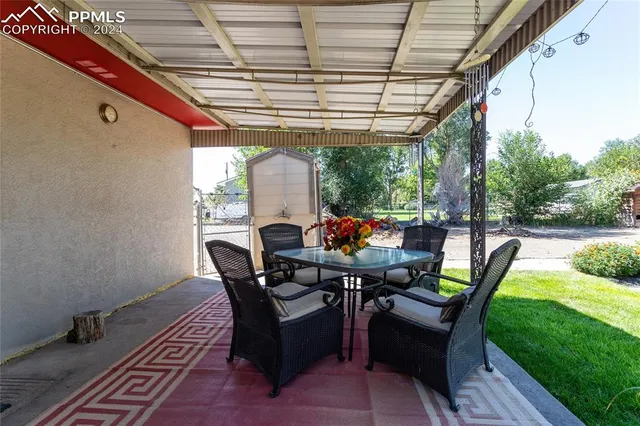 a dining room with furniture and garden view