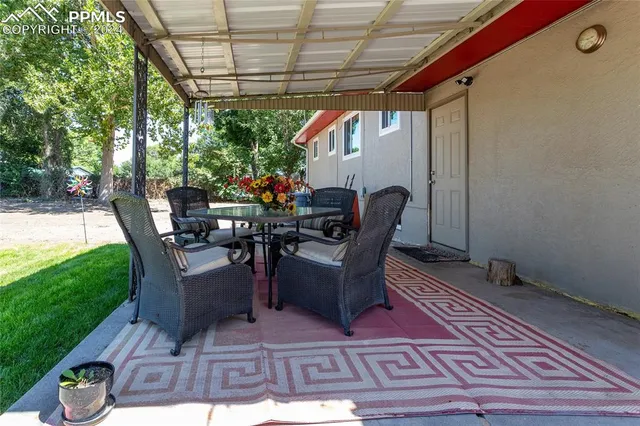 a dining room with furniture and garden view