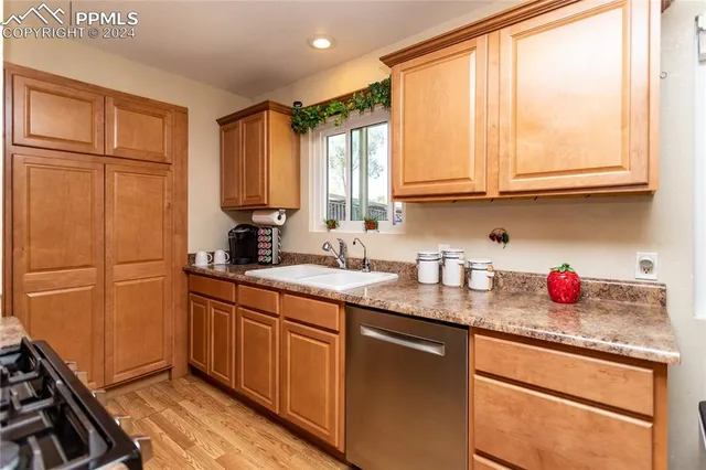 a kitchen with stainless steel appliances granite countertop a sink stove and cabinets