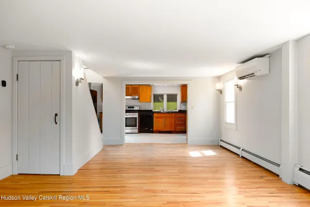 a view of a kitchen with wooden floor and electronic appliances